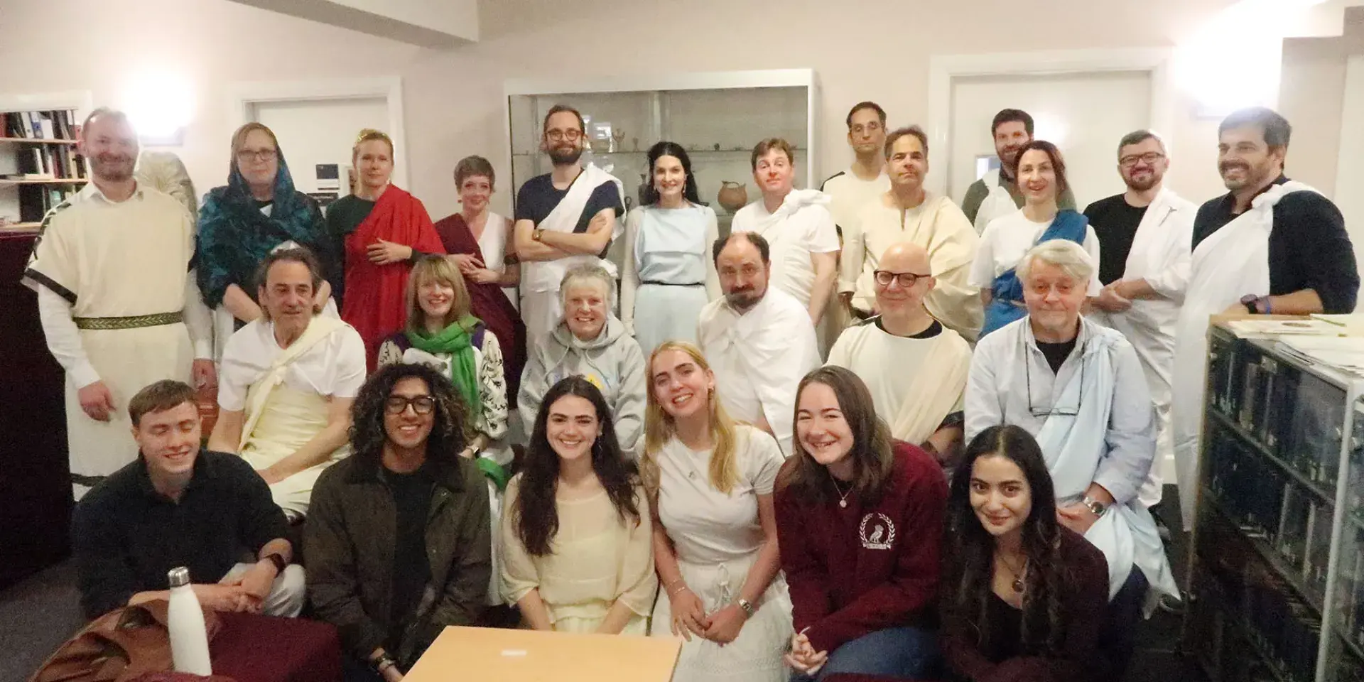 A group of HCA staff and students gathers, wearing various forms of ancient Roman and Greek dress