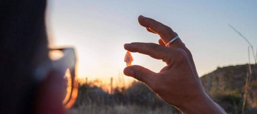 Student Holding an Orange Shiny Stone in Her Hand