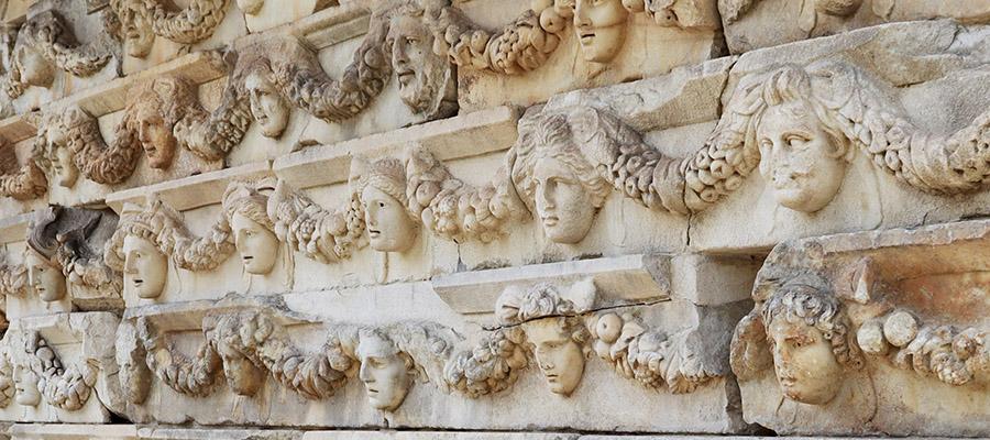 Rows of sculpted ancient Roman faces and garlands