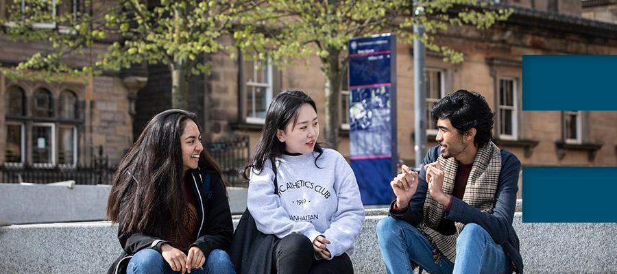 Three students chat on Central Campus