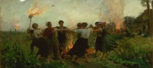 A group of women in traditional dresses dance in a circle around a bonfire at dusk, with a glowing moon overhead and village festivities in the background.