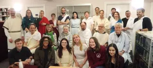 A group of HCA staff and students gathers, wearing various forms of ancient Roman and Greek dress