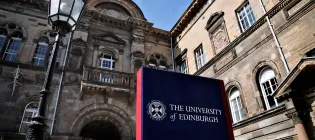 A sign for the University of Edinburgh beside a Victorian lamp in Elsie Inglis Quad in the Old Medical School.