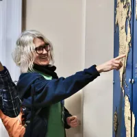 A male student and female member of staff discuss the map