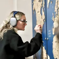 A female student with long blonde hair places a pin in the map