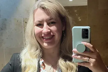 Tess now, she smiles broadly in a selfie