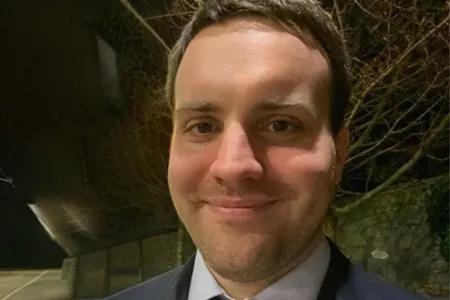 Fergal now. He has short dark hair and wears a suit and tie