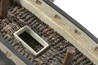 Folk art model of a slave ship on stand from the National Museum of African American History and Culture.
