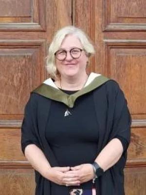 Student standing in graduating robes