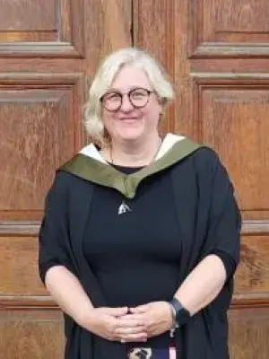 Student standing in graduating robes